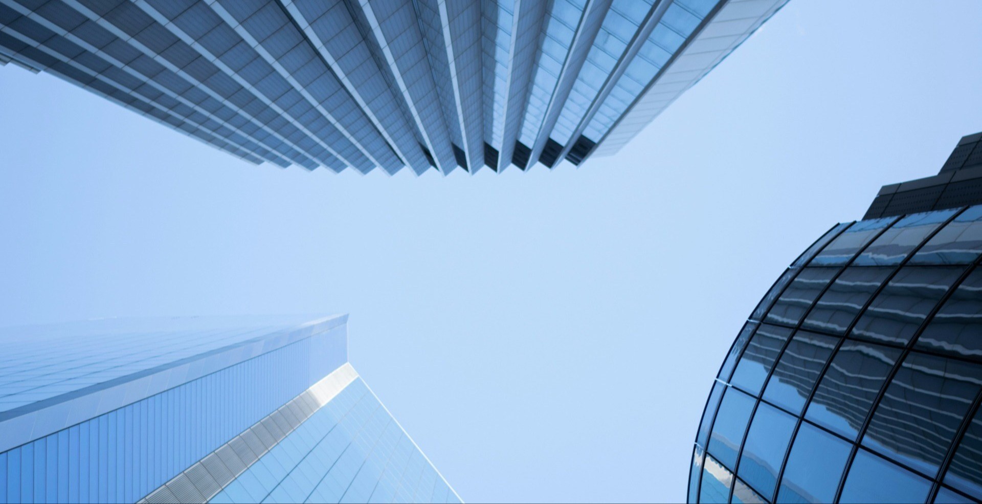 worm's view of office buildings and blue sky